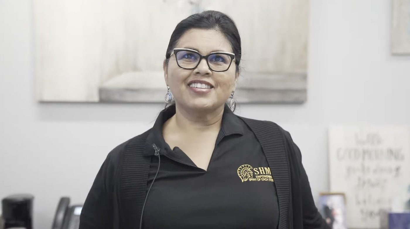 A school staff member smiling during her interview about Joyco